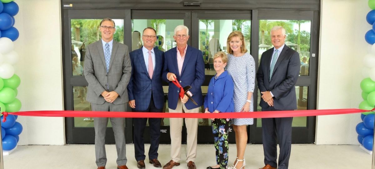 Siena Lakes leaders cut the red ribbon at the grand opening ceremony.